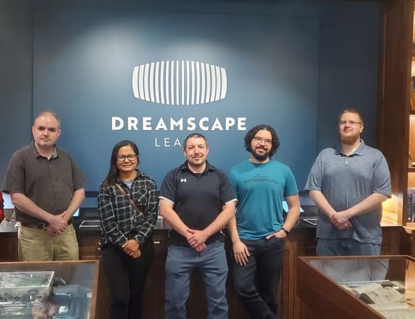 A photo of a few TEC community members standing inside the ASU Dreamscape Learning Lab